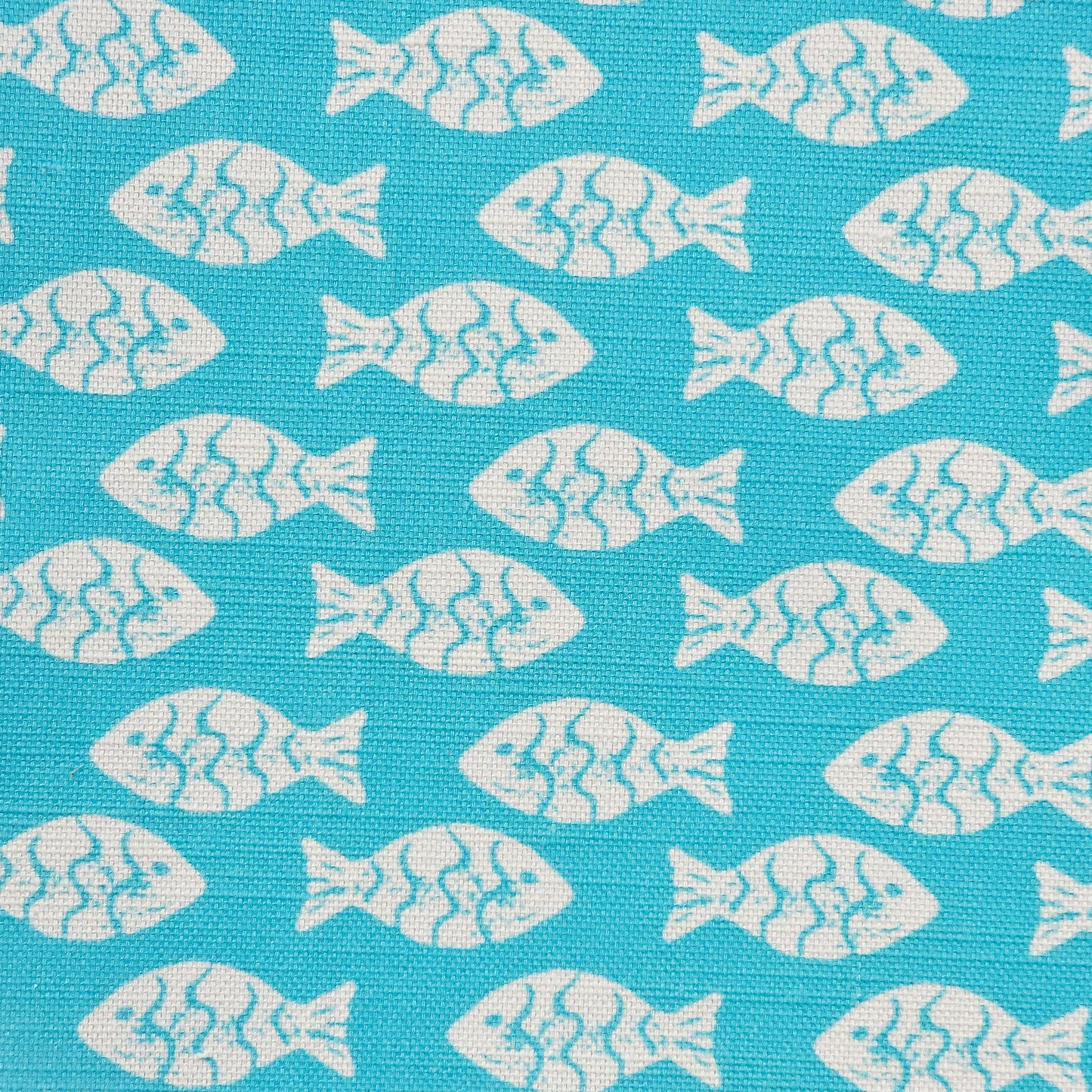 Shoal block‑print cotton linen fabric in off white featuring alternating stylised small fish motifs on an coral coloured background. ZIA LIVING.