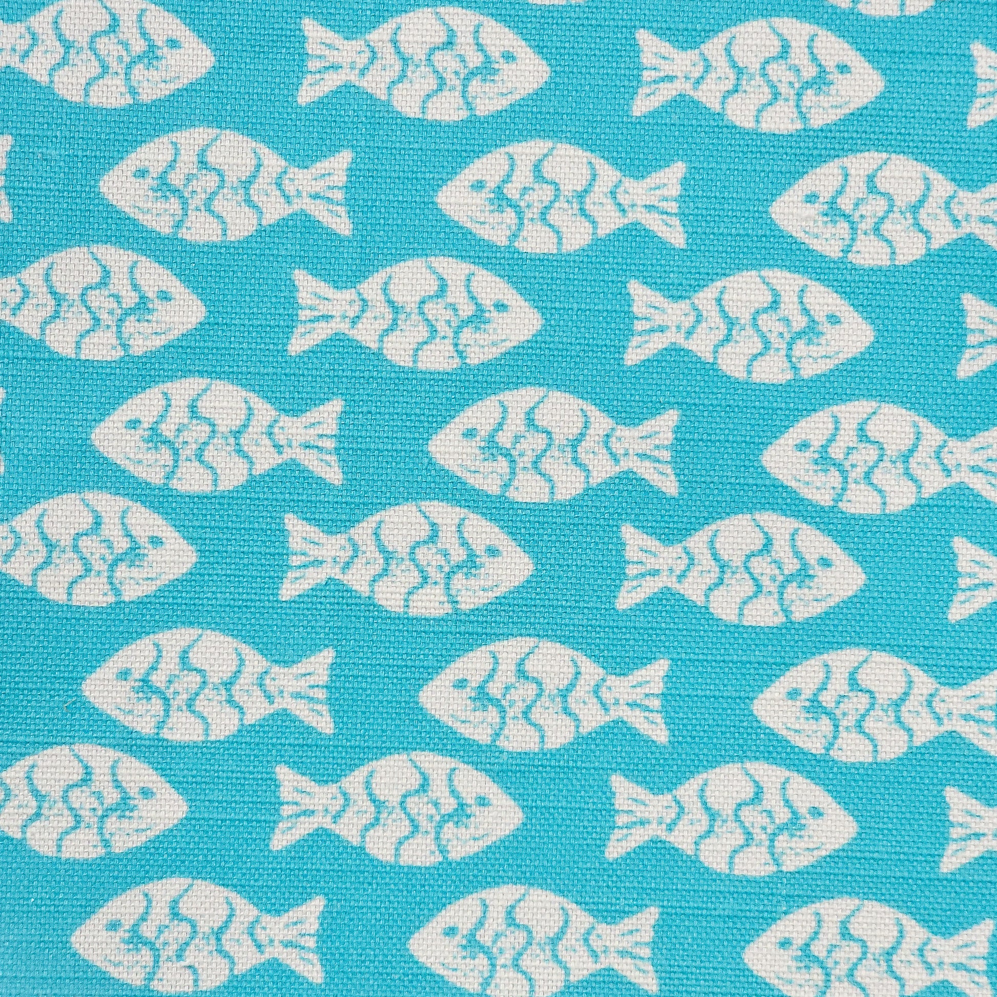 Shoal block‑print cotton linen fabric in off white featuring alternating stylised small fish motifs on an coral coloured background. ZIA LIVING.