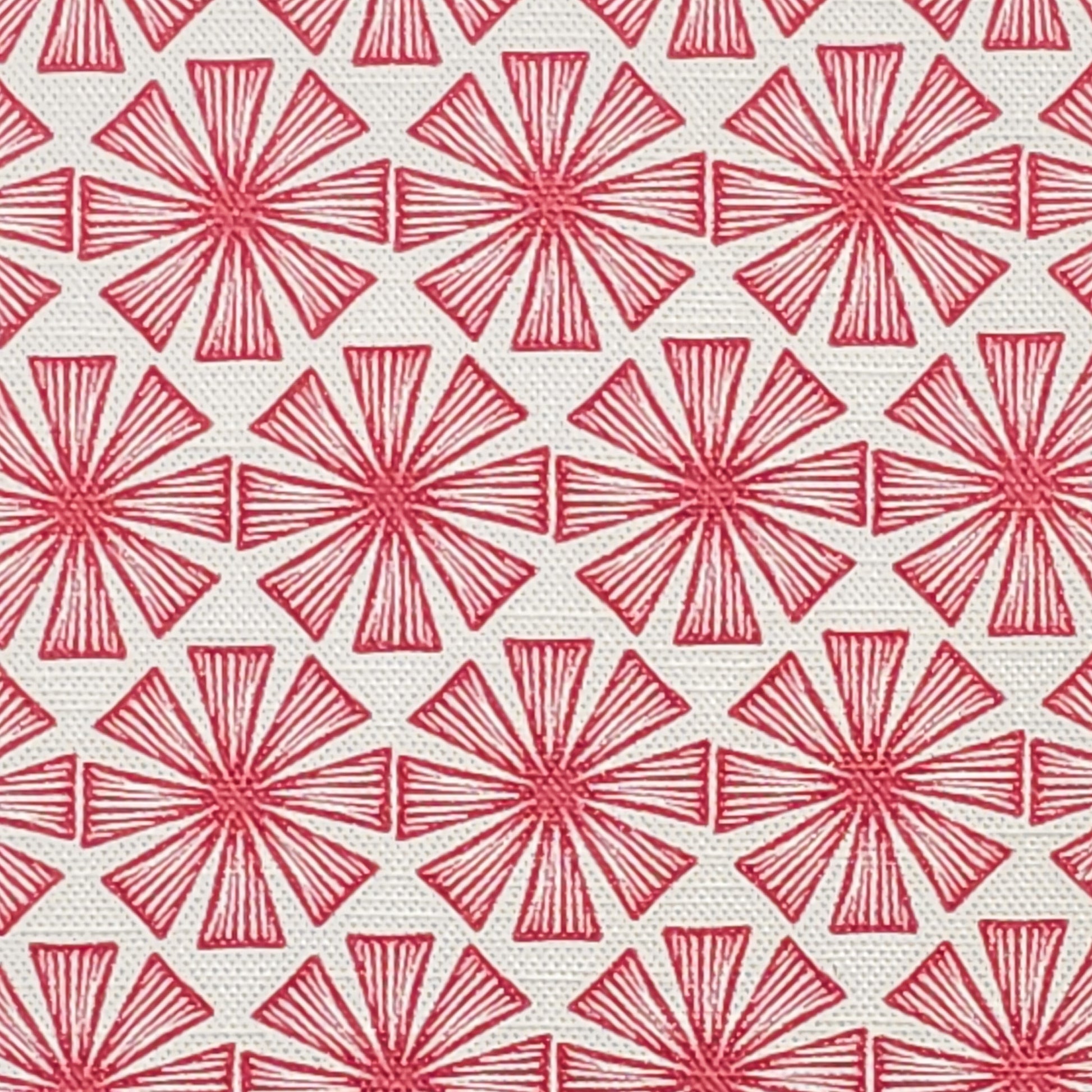 Stella cotton linen fabric featuring a bold red radiating motif in a repeating geometric pattern on an off‑white background. ZIA LIVING.