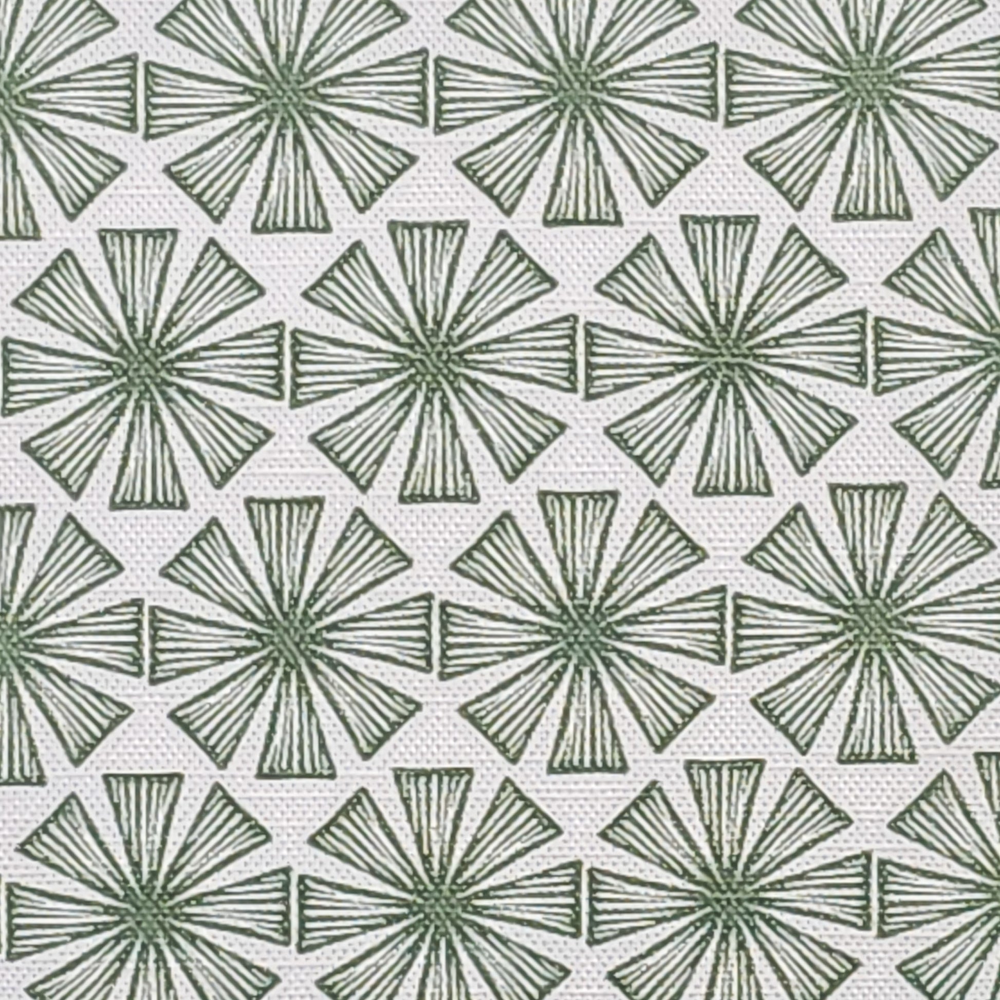 Stella cotton linen fabric featuring a bold green radiating motif in a repeating geometric pattern on an off‑white background. ZIA LIVING.