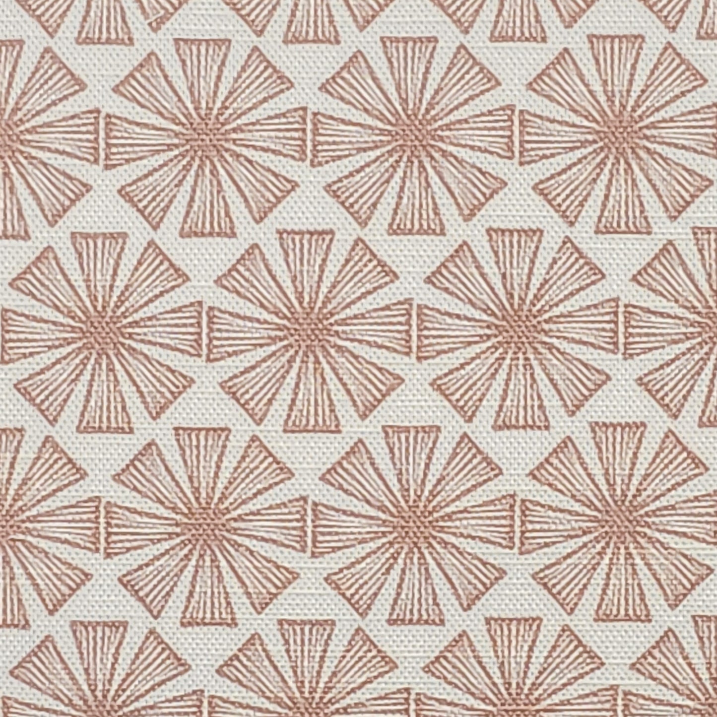 Stella cotton linen fabric featuring a muted nude-pink radiating motif in a repeating geometric pattern on an off‑white background. ZIA LIVING.