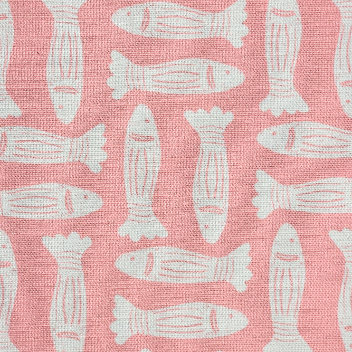 Fishes block‑print cotton linen fabric in off white featuring alternating stylised fish motifs on an coral background. ZIA LIVING.