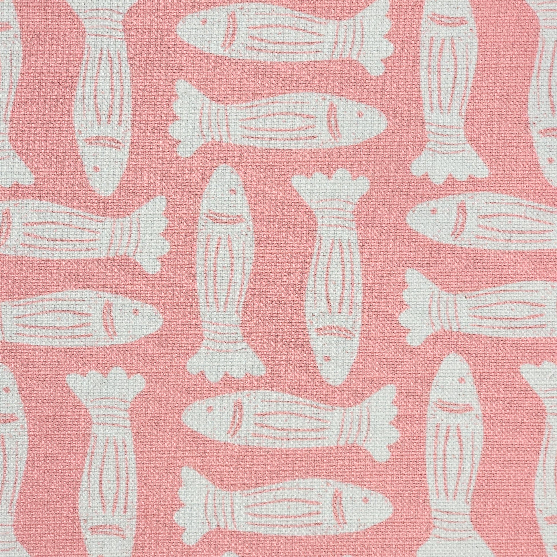 Fishes block‑print cotton linen fabric in off white featuring alternating stylised fish motifs on an coral background. ZIA LIVING.