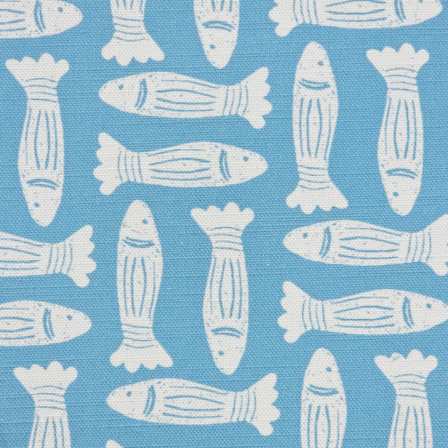 Fishes block‑print cotton linen fabric in off white featuring alternating stylised fish motifs on an sea blue background. ZIA LIVING.