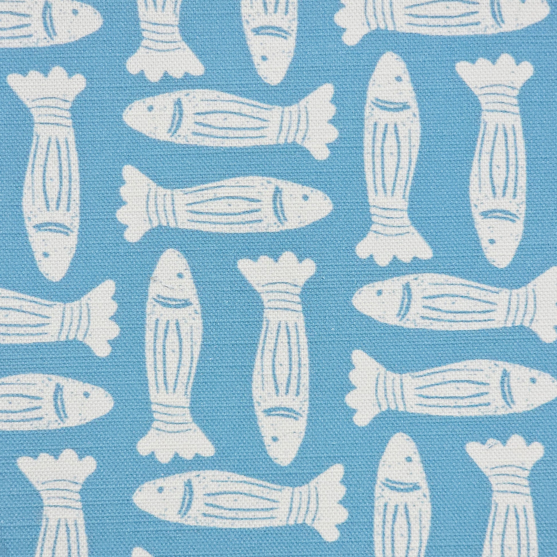 Fishes block‑print cotton linen fabric in off white featuring alternating stylised fish motifs on an sea blue background. ZIA LIVING.