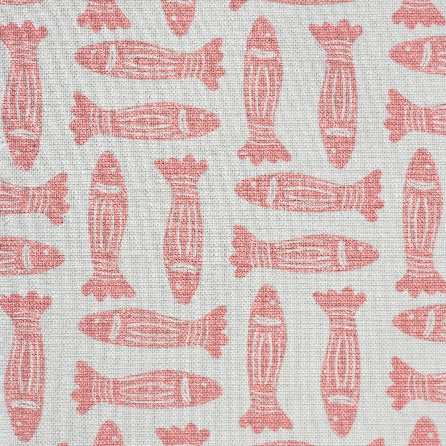 Fishes lino print cotton linen fabric in coral, featuring alternating stylised fish motifs on an off‑white background. ZIA LIVING.