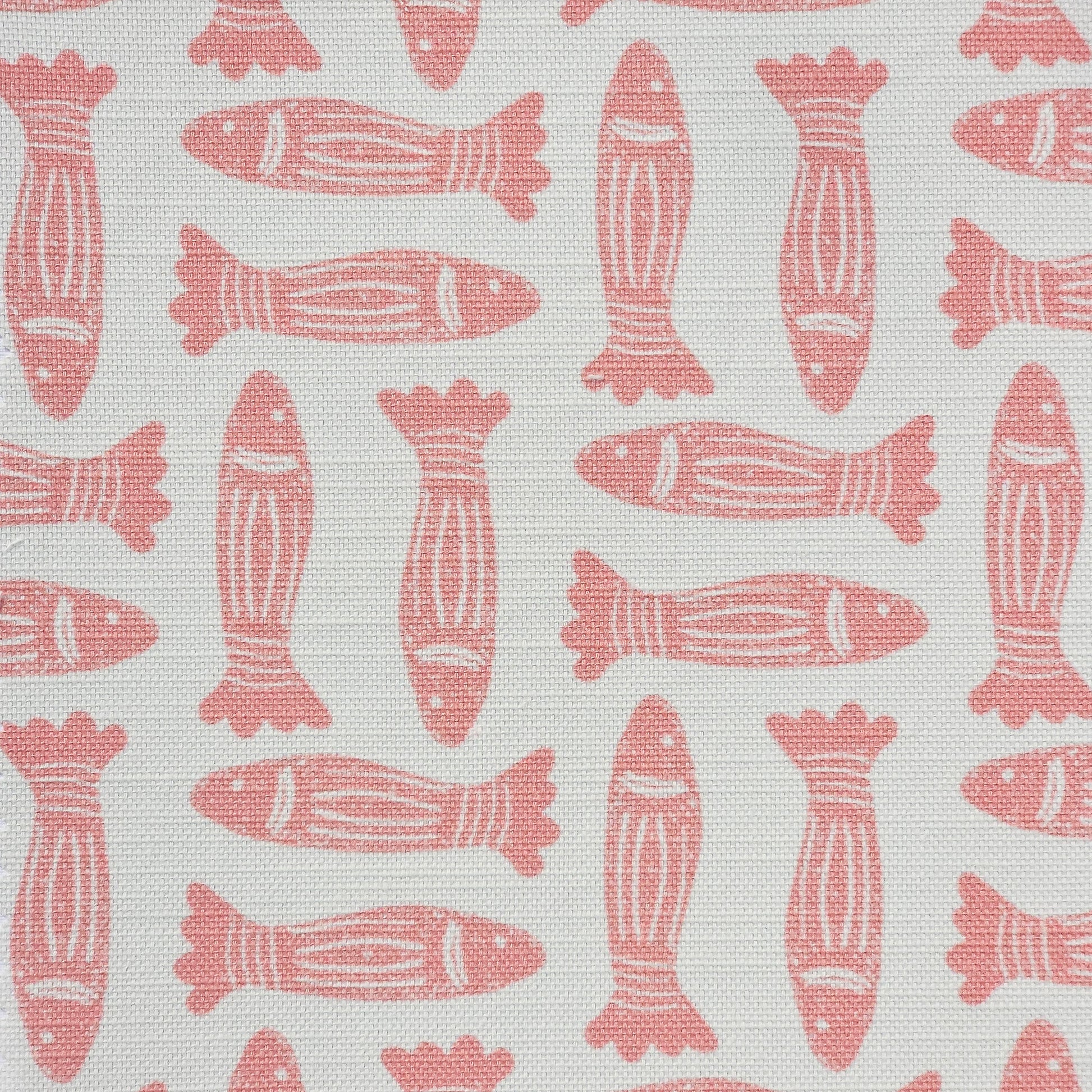 Fishes lino print cotton linen fabric in coral, featuring alternating stylised fish motifs on an off‑white background. ZIA LIVING.