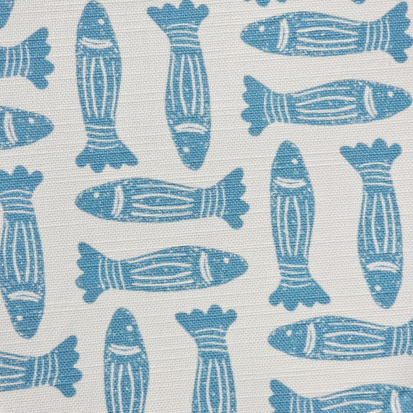 Fishes lino print cotton linen fabric in blue, featuring alternating stylised fish motifs on an off‑white background. ZIA LIVING.