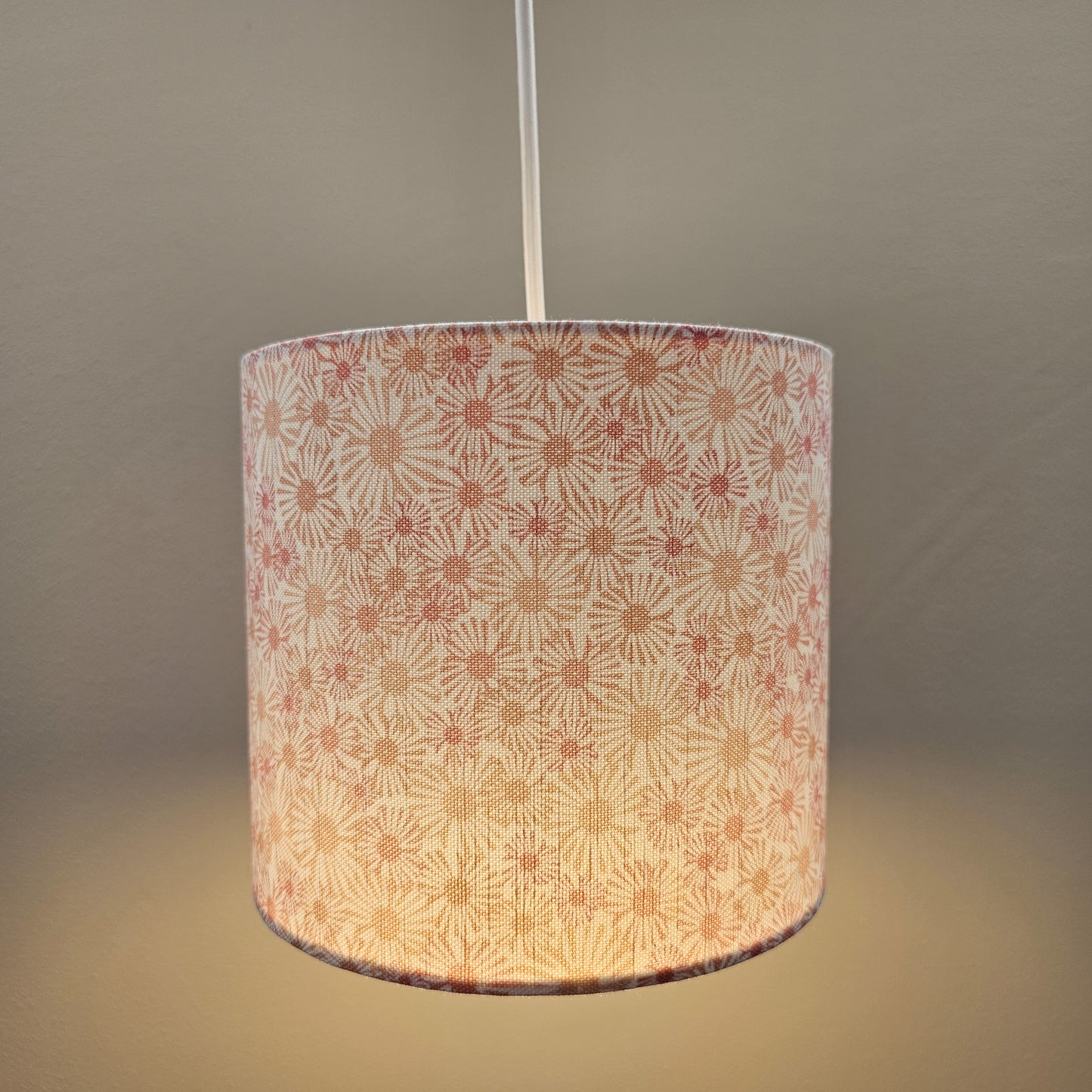 Daisy print drum lampshade with soft pink and beige floral motifs on a light background, ceiling shade cosy — ZIA LIVING