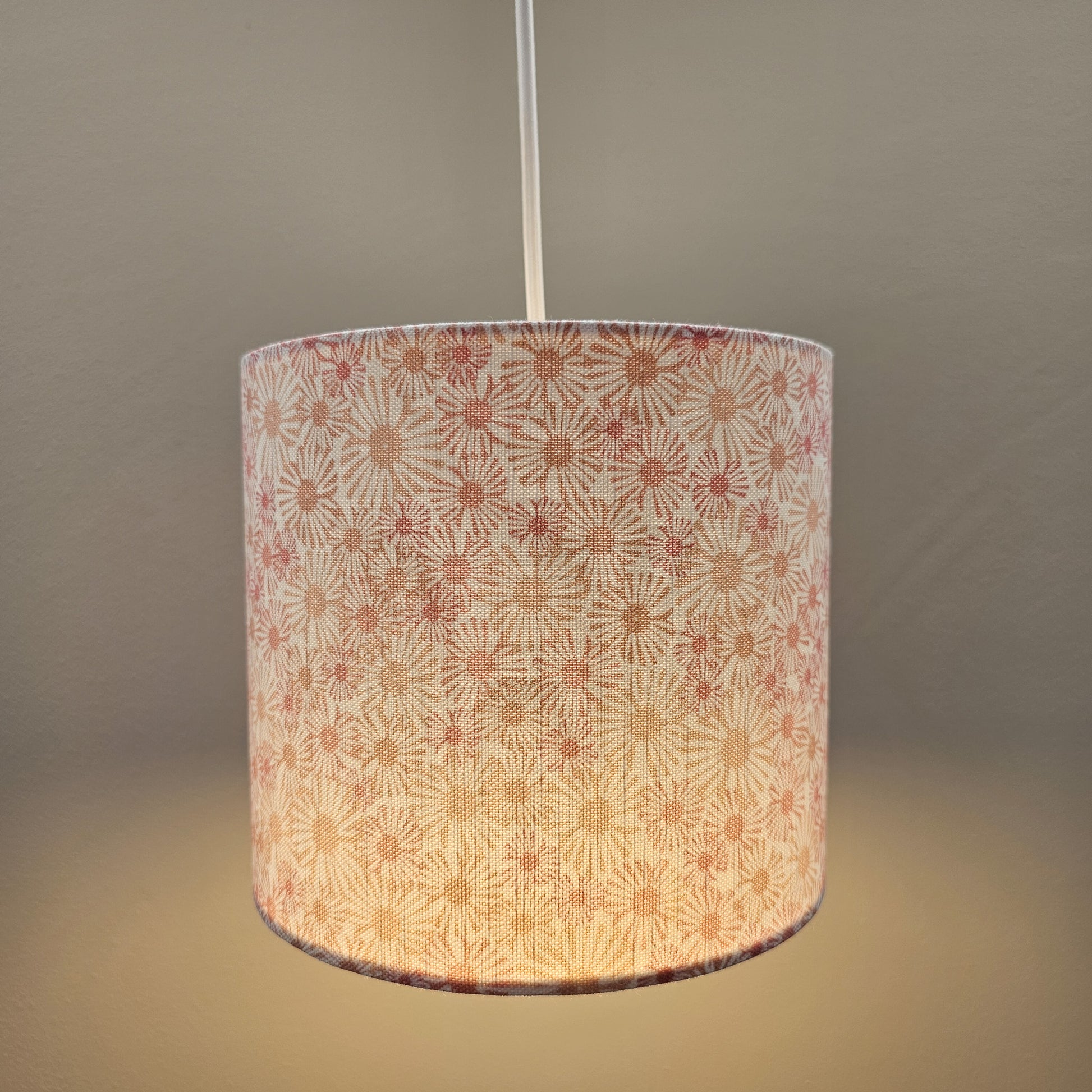 Daisy print drum lampshade with soft pink and beige floral motifs on a light background, ceiling shade cosy — ZIA LIVING