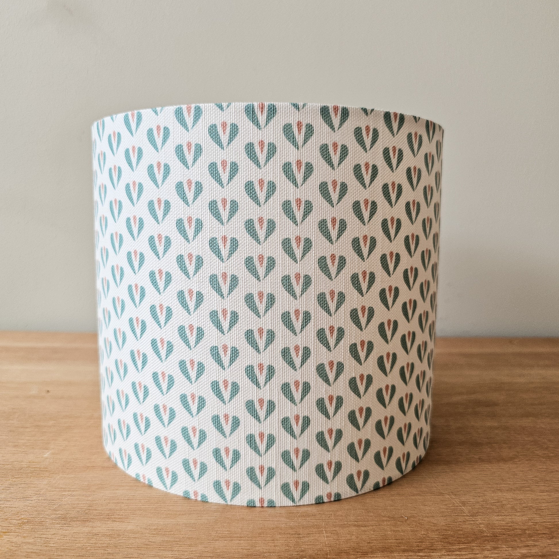 Heart motif lampshade by ZIA LIVING, featuring a repeating teal and pink pattern on a light cotton‑linen shade, front view
