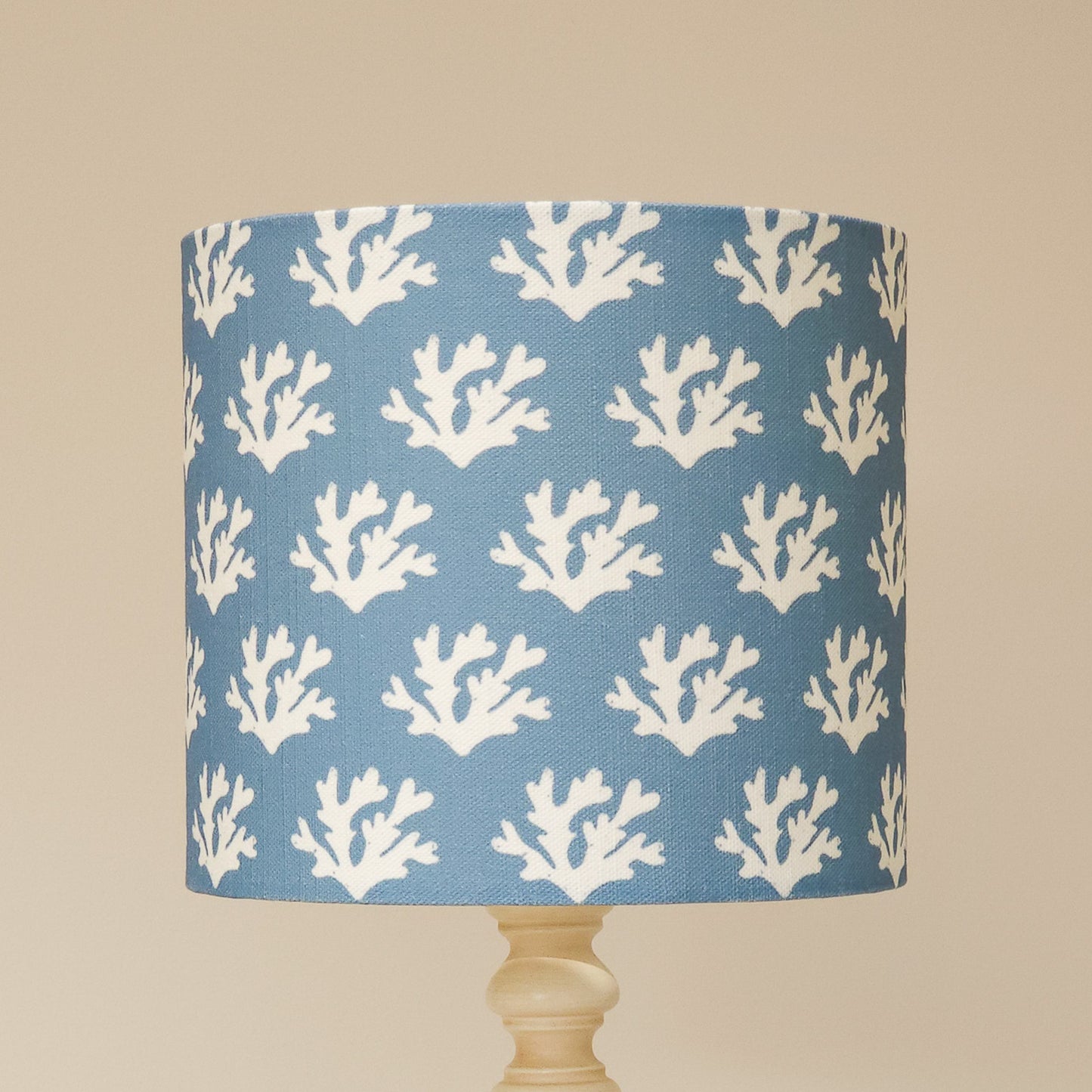 Zia Living Seaweed drum lampshade with white seaweed coral pattern on a blue background. 