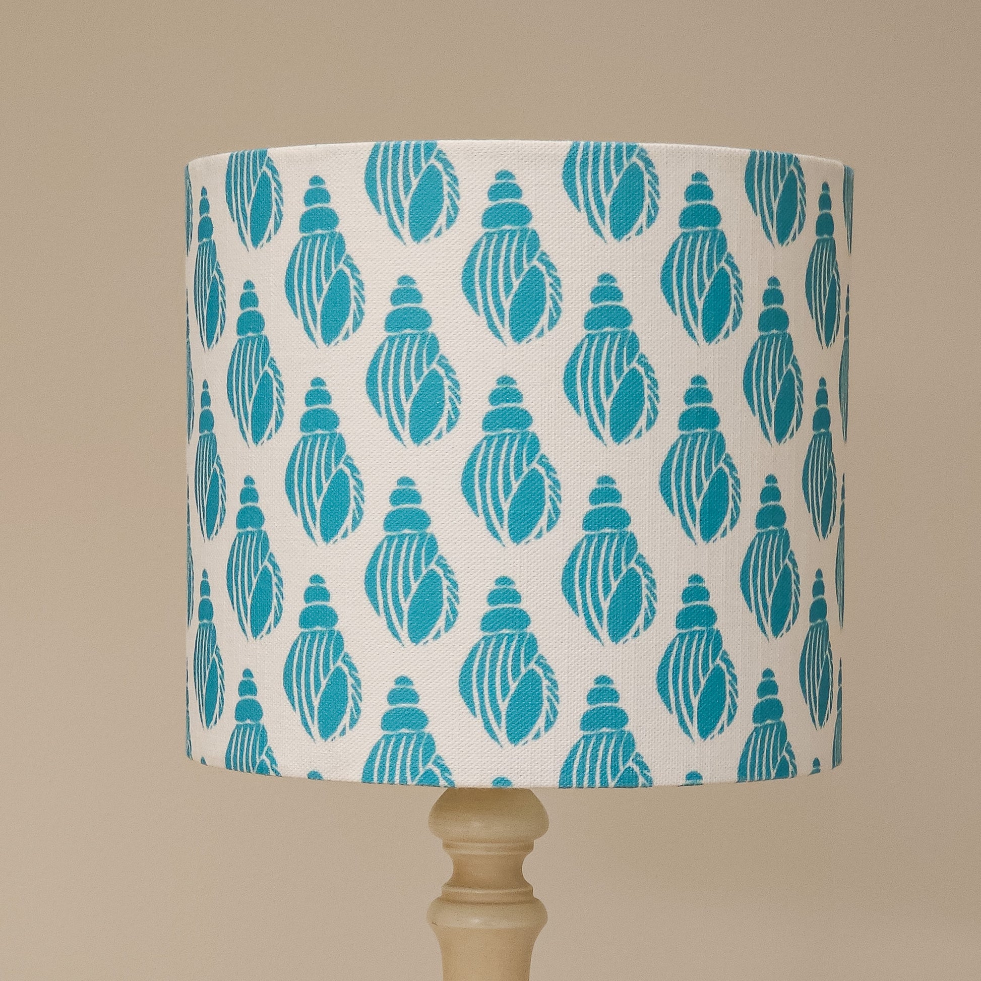 Lampshade with teal shell pattern on white background by Zia Living