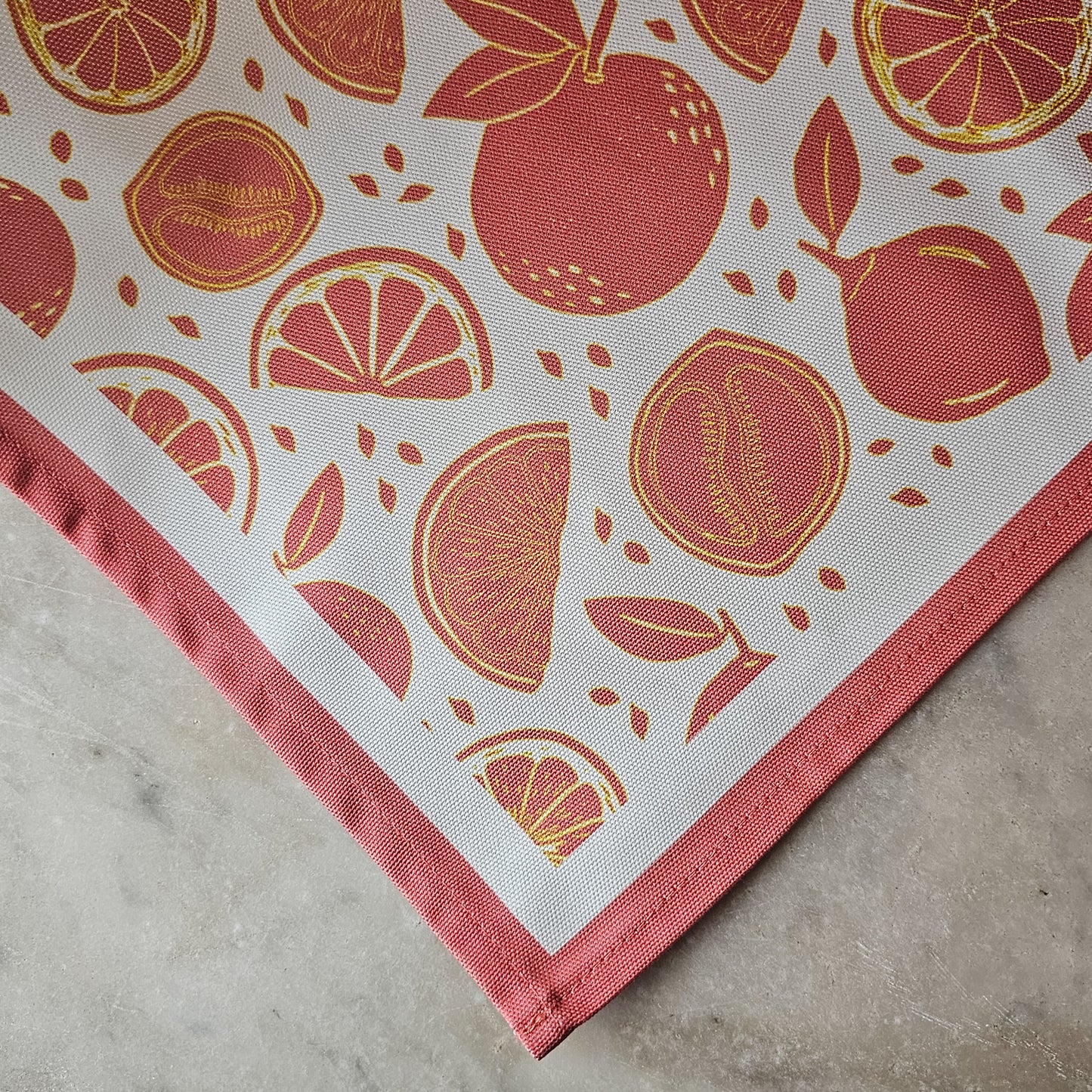 An orange‑and‑white citrus‑print tea towel from ZIA LIVING close up