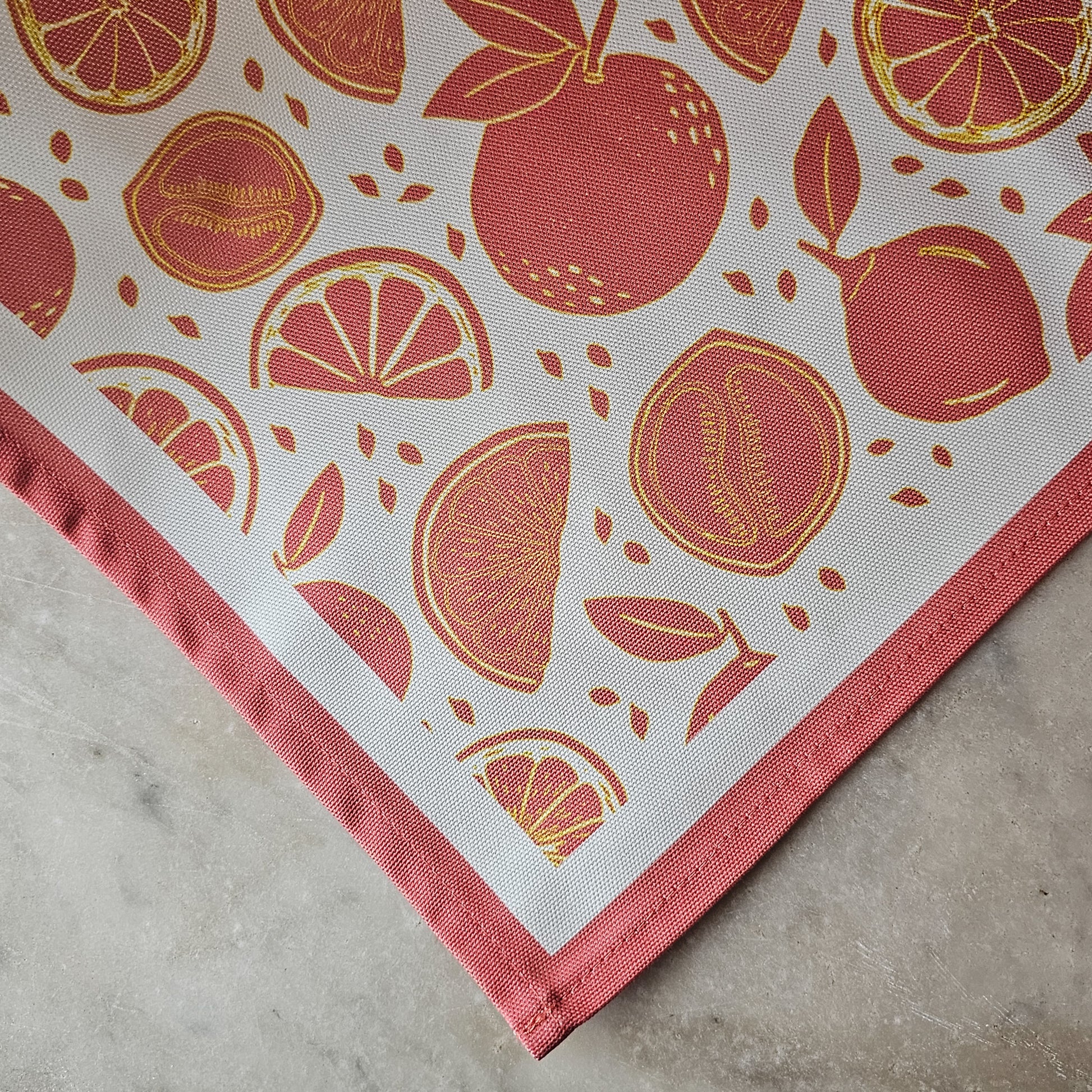 An orange‑and‑white citrus‑print tea towel from ZIA LIVING close up